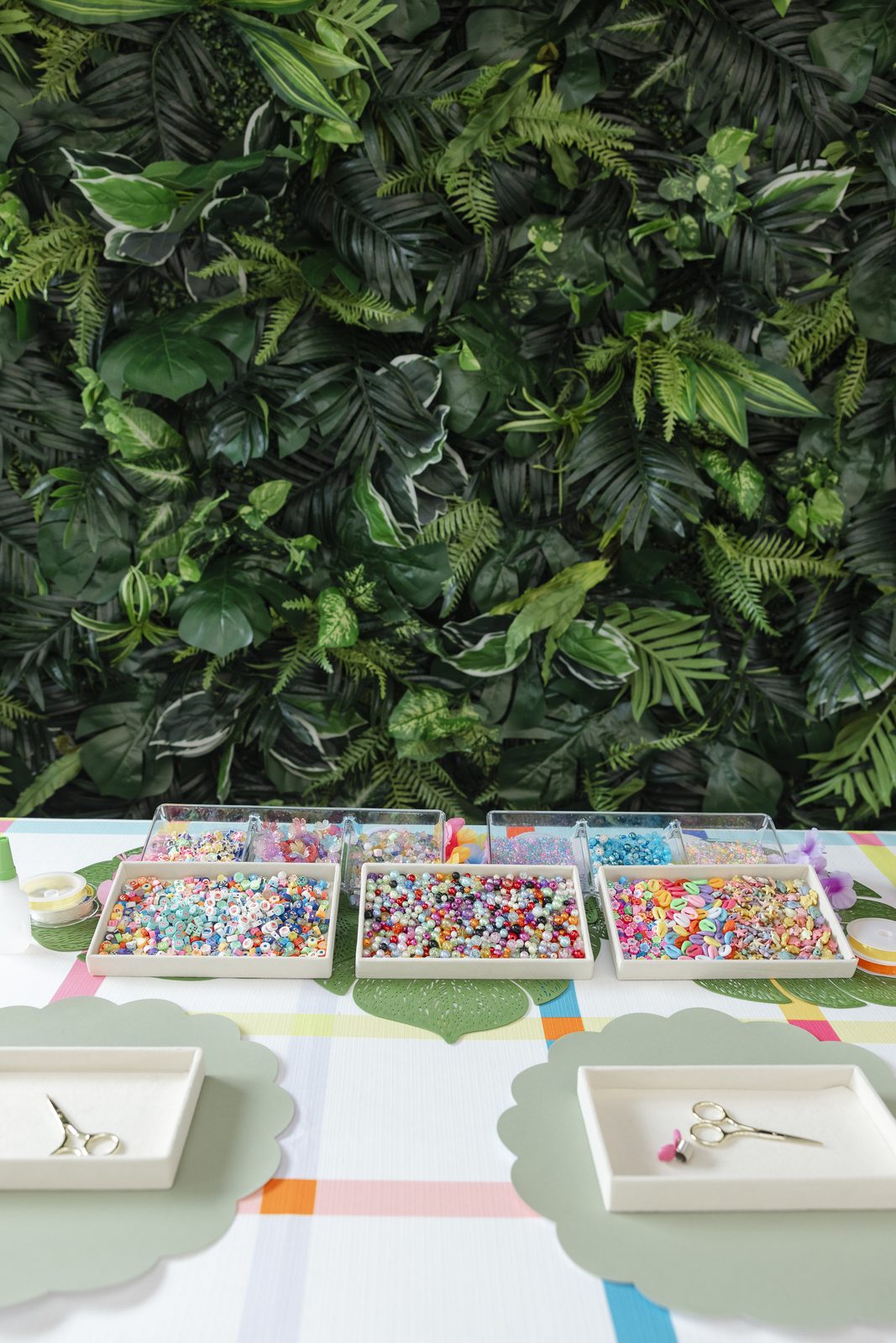 A Charm Bar table set in front of a full greenery wall