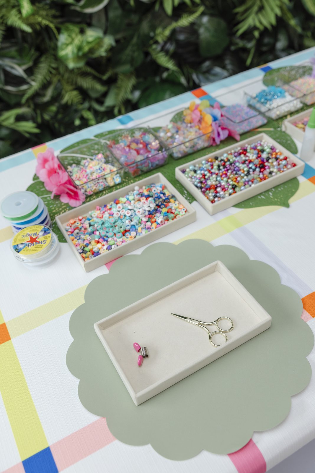 A Charm Bar place setting with a scalloped mat, tray and small scissors