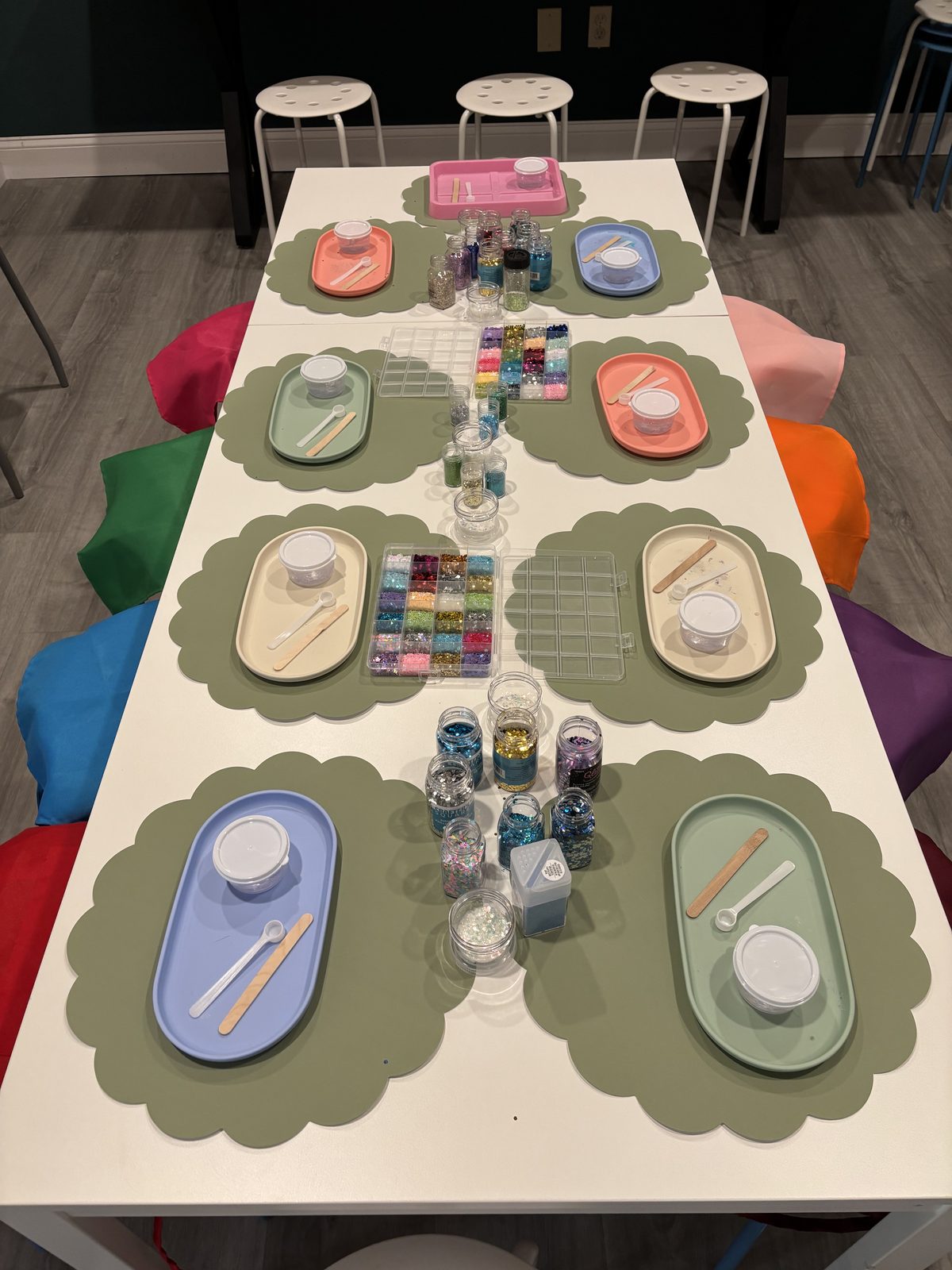 A long Craft Bar table set with scalloped placemats and prepared activity trays