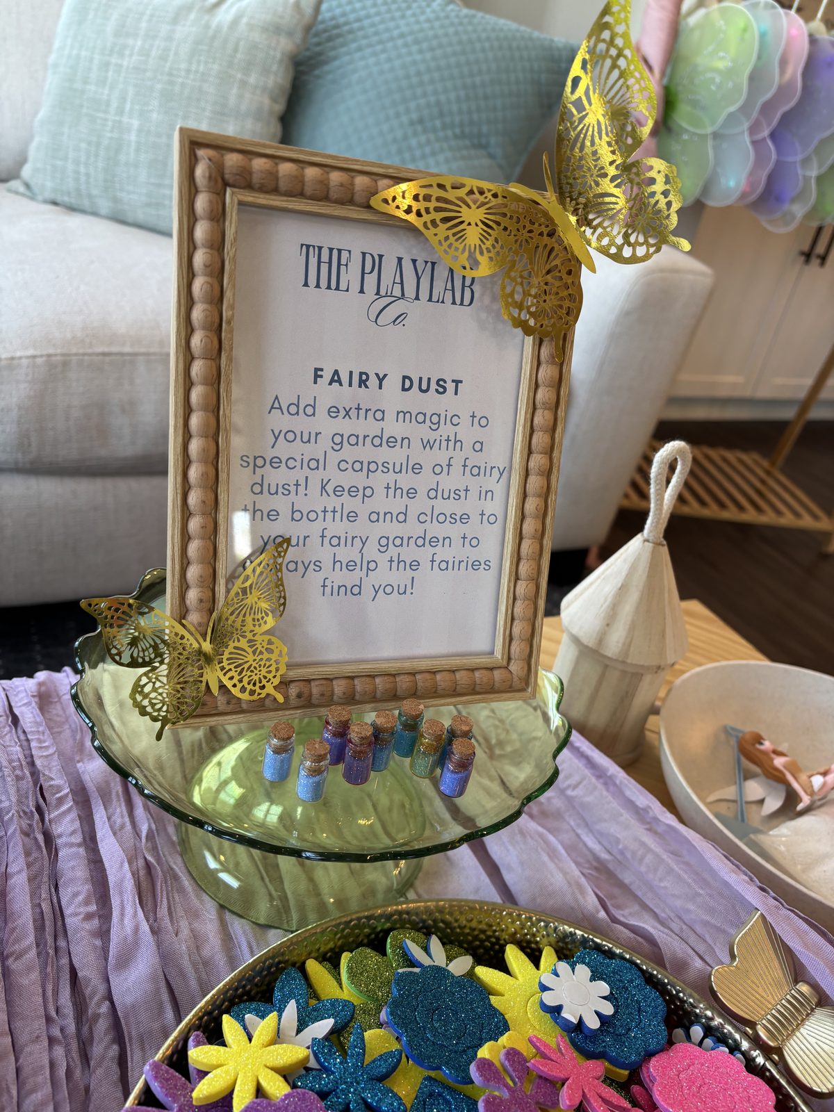 A framed Fairy Dust card at a PlayLab Co. Fairy Gardens experience