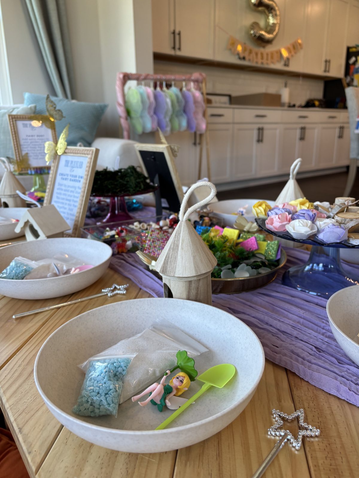 Fairy garden bowls prepared with soil, figures and tools for each guest