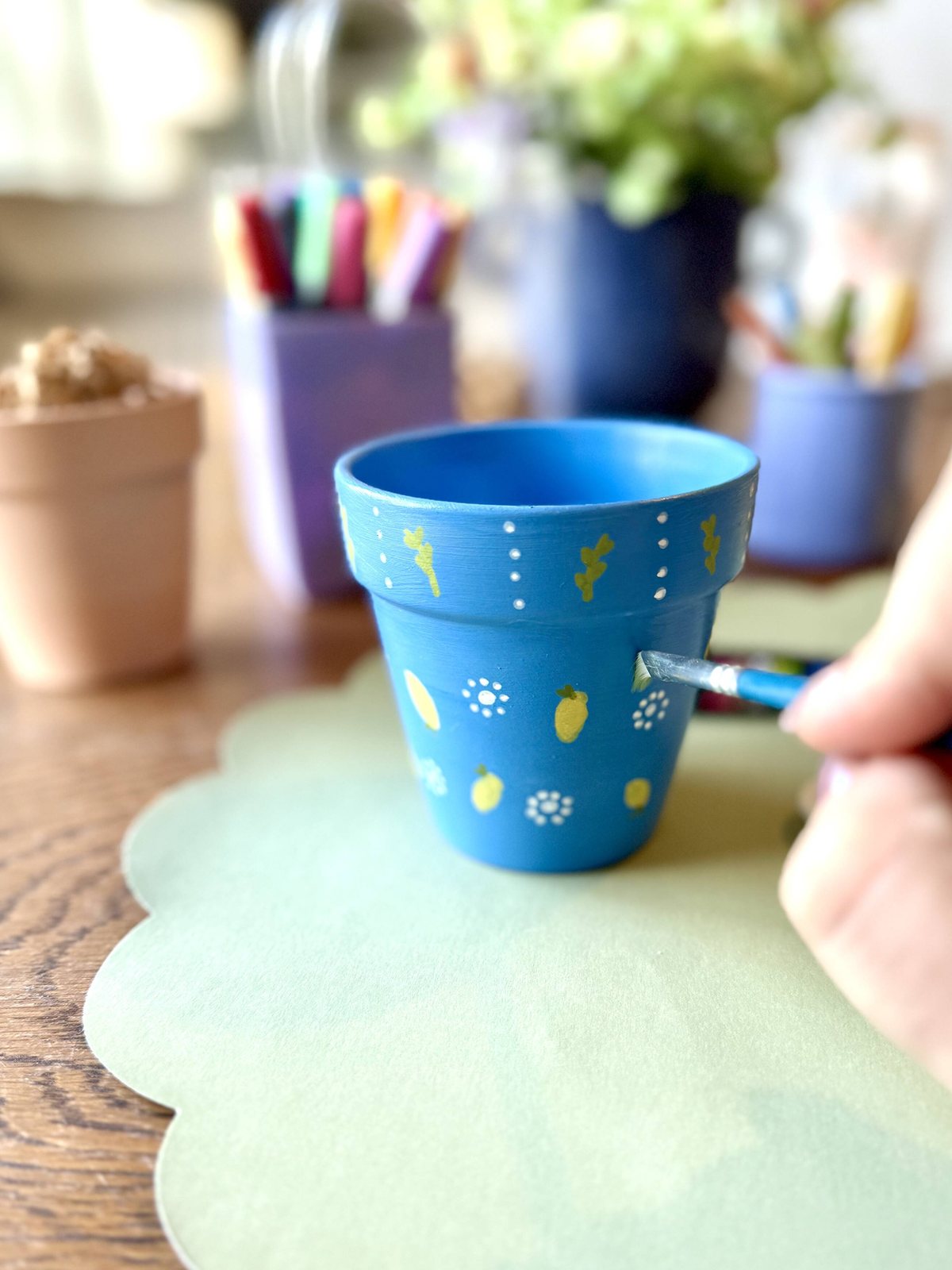 A child painting a clay pot